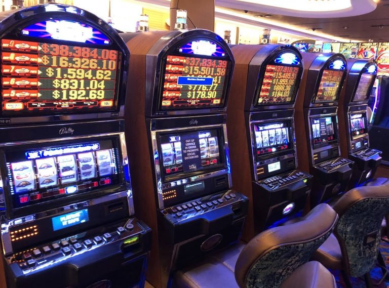 Mobile phone displaying a live blackjack table interface with dealer video feed and betting buttons